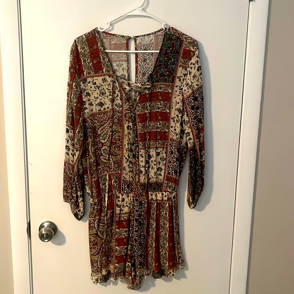 Elastic waist romper. Cross chest tie. Long sleeve with multicolor patterns.